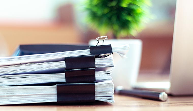 Stack of documents placed on a business desk