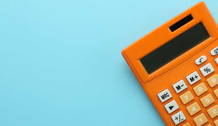 Orange calculator on a bright blue paper background.