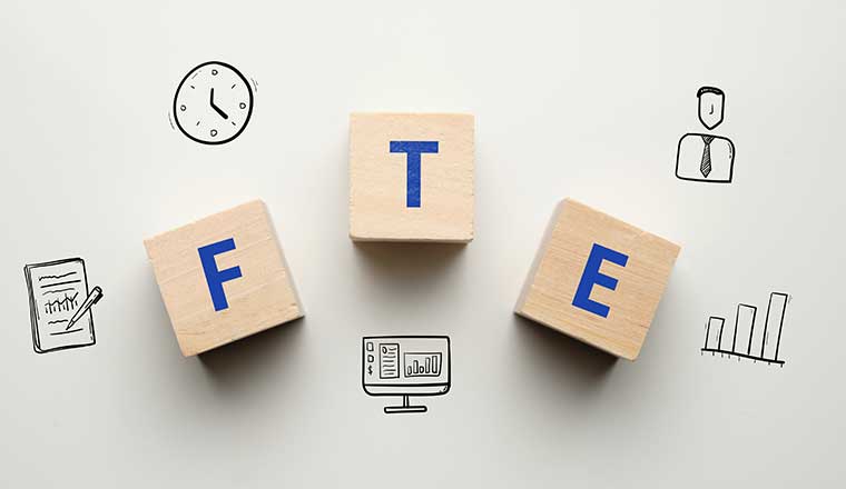 Acronym FTE or Full Time Equivalent. Text on wooden cubes.