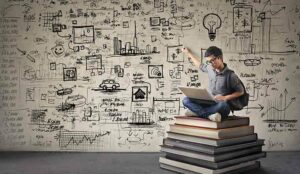 guy sitting on books