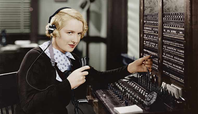 Switchboard operator at old fashioned switchboard