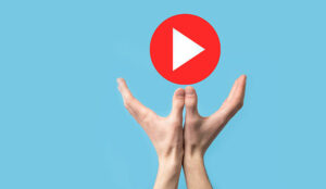 Hands holding play button