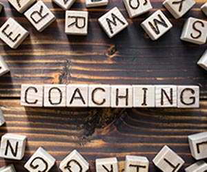 The word coaching composed of wooden cubes with letters