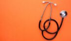 Medical stethoscope on a orange background. Health care concept