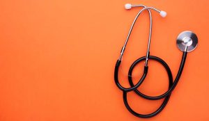 Medical stethoscope on a orange background. Health care concept