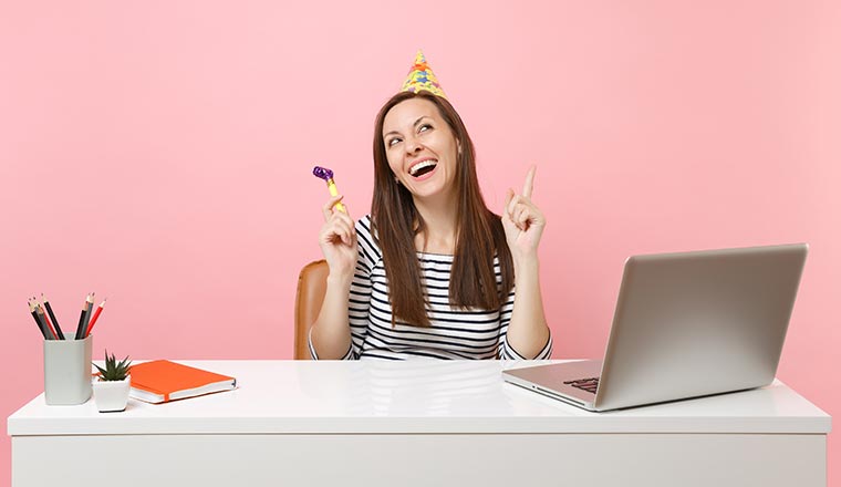 Happy employee sat with laptop