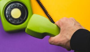 Green phone on coloured background