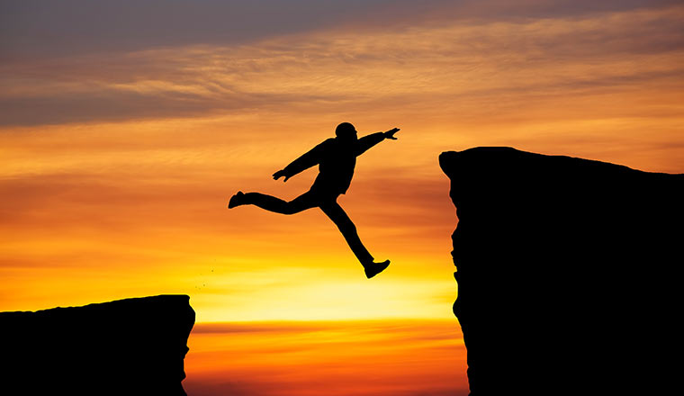 Person jumping across the gap