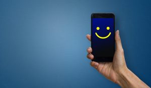 Mobile phone with smiley face inbound call and customer satisfaction