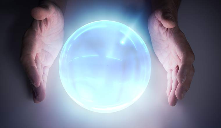 Magician or fortune teller is predicting future with crystal sphere