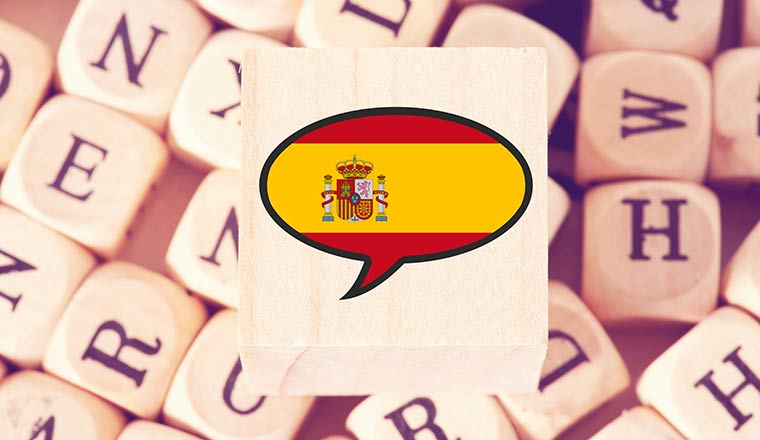 Spanish Flag in speech bubble over letters