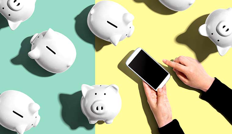 Piggy banks with person using a smartphone