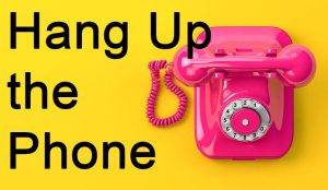 Vintage pink telephone on yellow background.