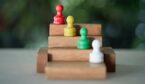 Chess pawn on a toy wooden ladder