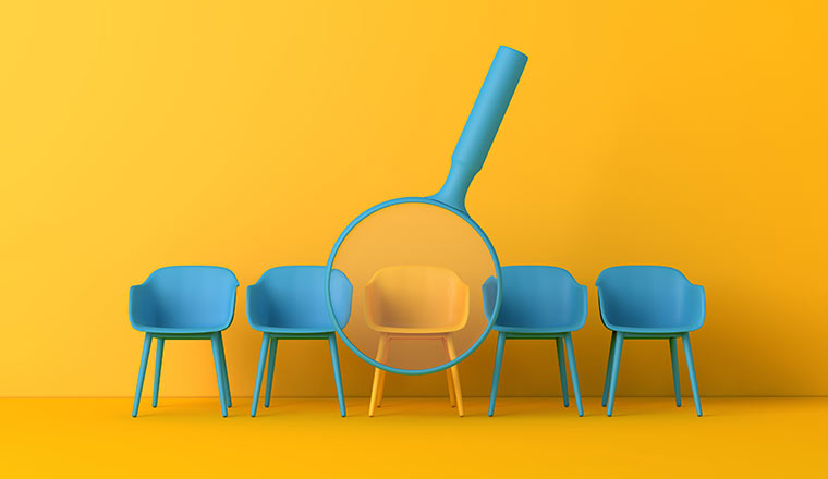 Office chair with magnifying glass. Recruitment concept.