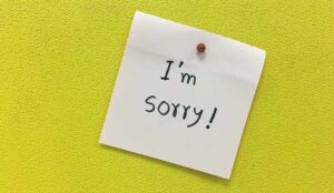 A note with i am sorry message on yellow background.