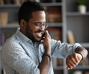 Person checking time while making phone call c