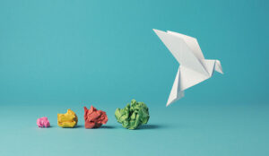 Colorful crumpled paper balls with a paper dove opportunity concept