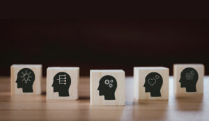 Personality concept with heads with icons on cubes