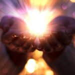 Miracle concept with light in palm of hands