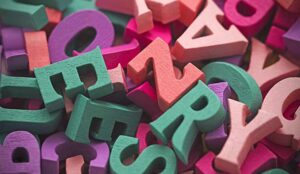 Pile of colorful painted wooden letters.