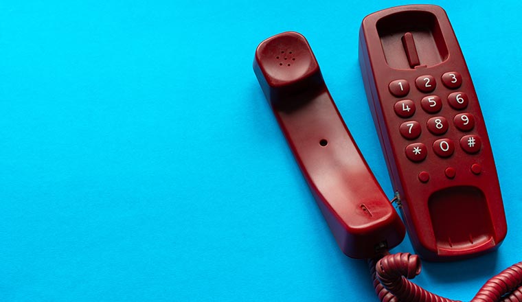 Red Old fashion landline home phone with handset off hook