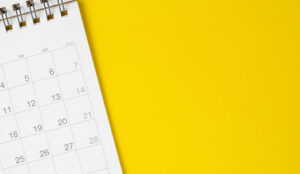 White clean calendar on solid yellow background