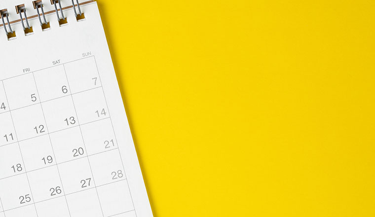 White clean calendar on solid yellow background
