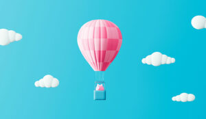 Piggy bank in hot air balloon on blue sky, with clouds