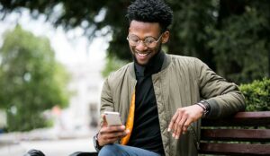 Person on bench with mobile phone