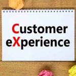 words CX customer experience on white note