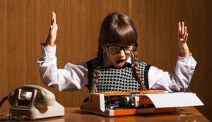 frustrated girl at typewriter