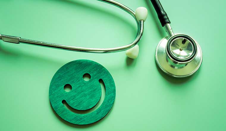 Patient satisfaction concept. Stethoscope and smile face as good assessment.