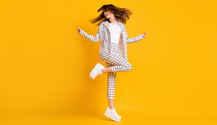 Person moving and dancing on yellow background