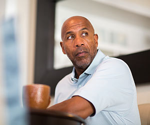 A person sat at desk with a coffee