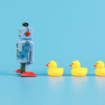 Leadership concept with robot ahead of rubber ducks