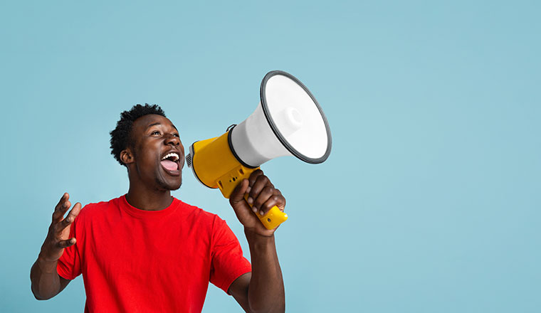 Person Making Announcement With Megaphone In Hands