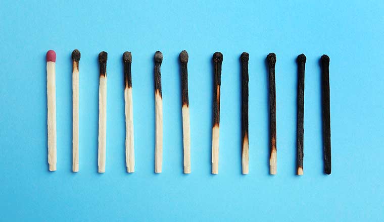 Agent Burnout Concept Row of burnt matches and whole one