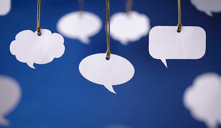 Blank white speech bubbles hanging from a cord