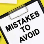 mistakes to avoid is written on a white sheet of paper that lies on a colored background among stationery