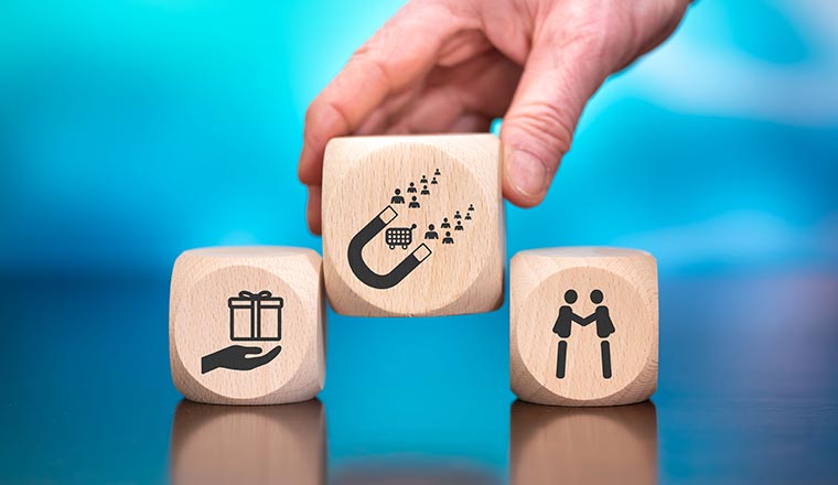 Wooden blocks with symbol of customer loyalty concept on blue background