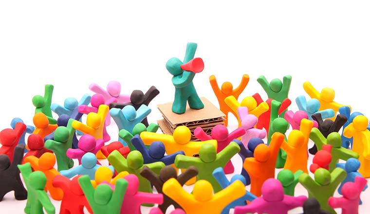 plasticine speaker standing on podium standing out from crowd
