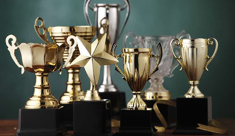 Group of the trophies on green background