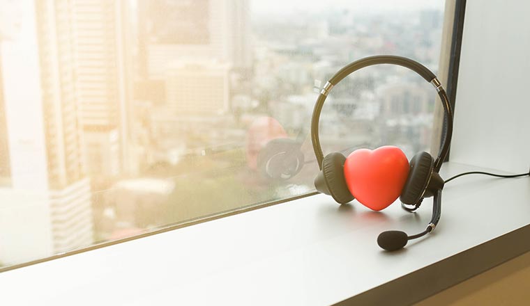Headphones for call center with heart symbol put beside the office window