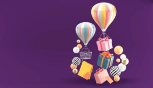 Balloon, gift box and shopping bag surrounded by colorful balls