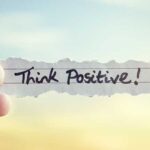 Think positive message on piece of paper