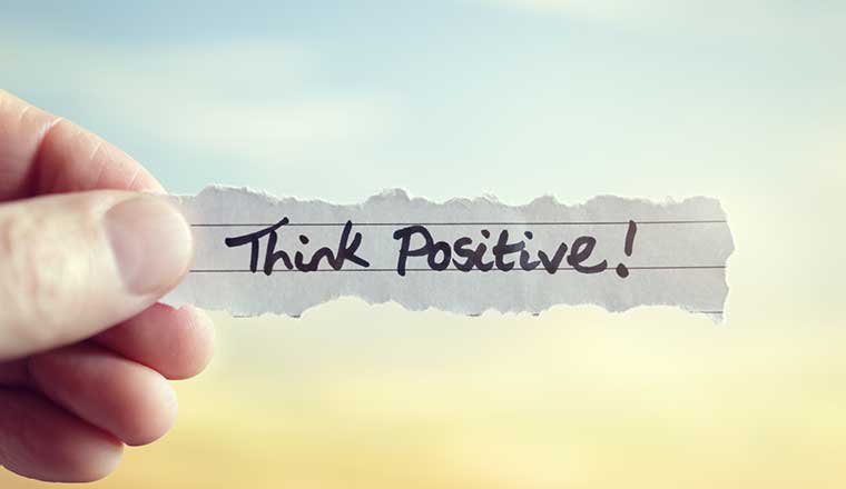 Think positive message on piece of paper