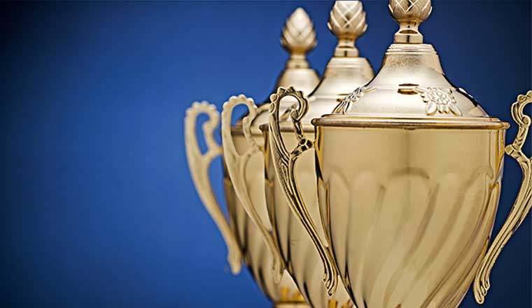 Receding staggered row of three gold trophy cups