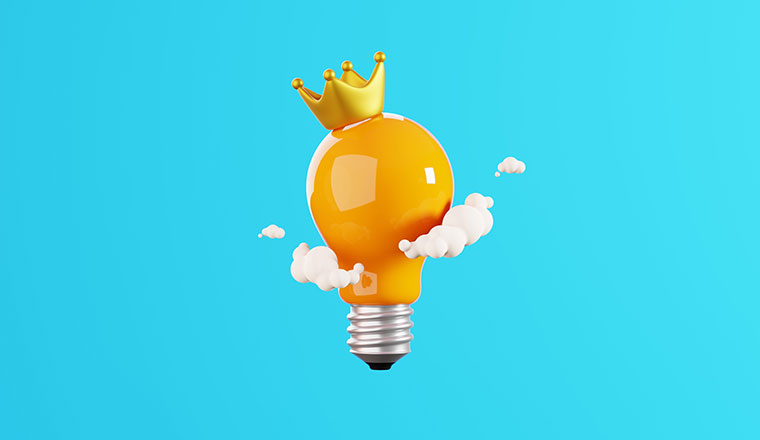 Light bulb with crown and cloud isolated on blue background