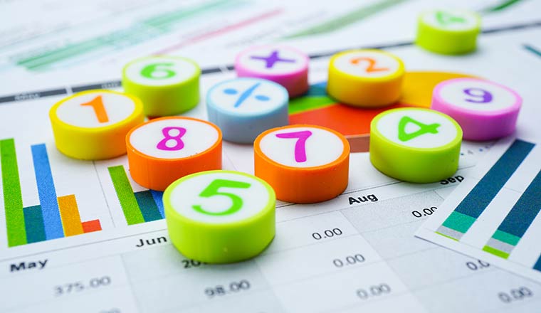 Numbers and mathematical symbols on business charts